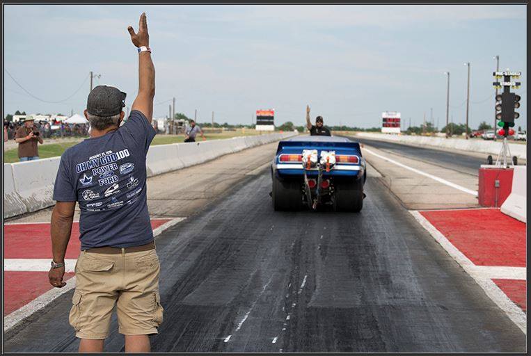 crew of pop bang boom injected nitro funny car lining it up for staging