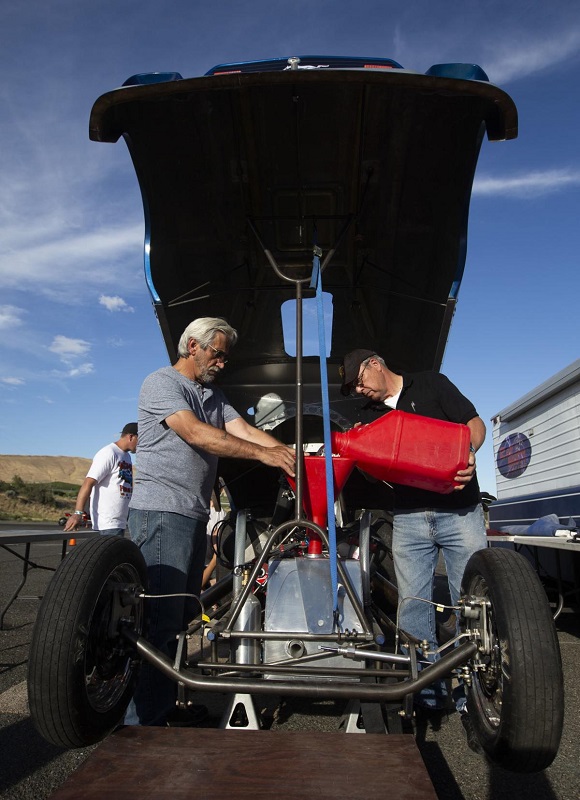 Butch Brewer and Don Harris fueling up the pop bang boom injected nitro funny car